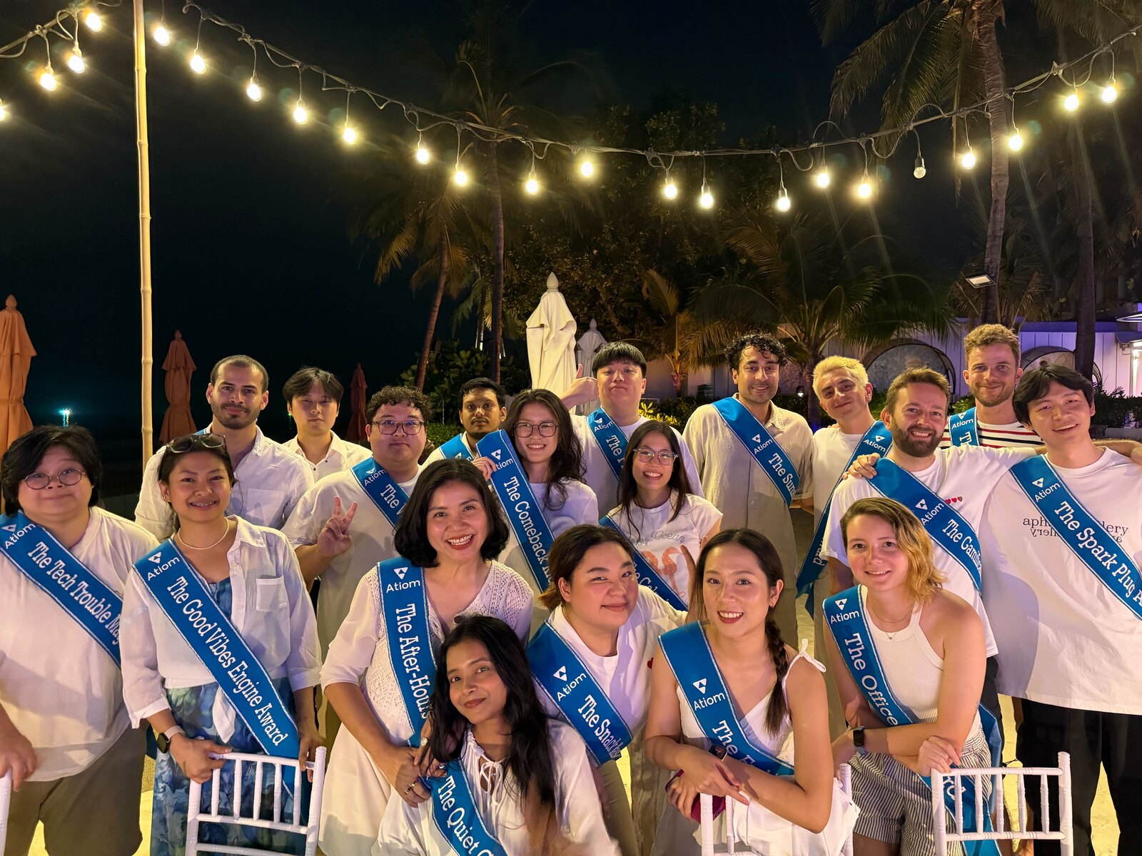 The Atiom team at a company offsite, in white with recognition sashes